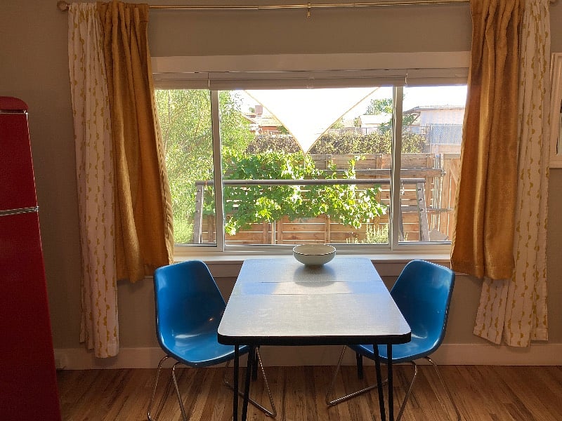 South facing window lets lovely light in. Original mid century modern dining table and chairs