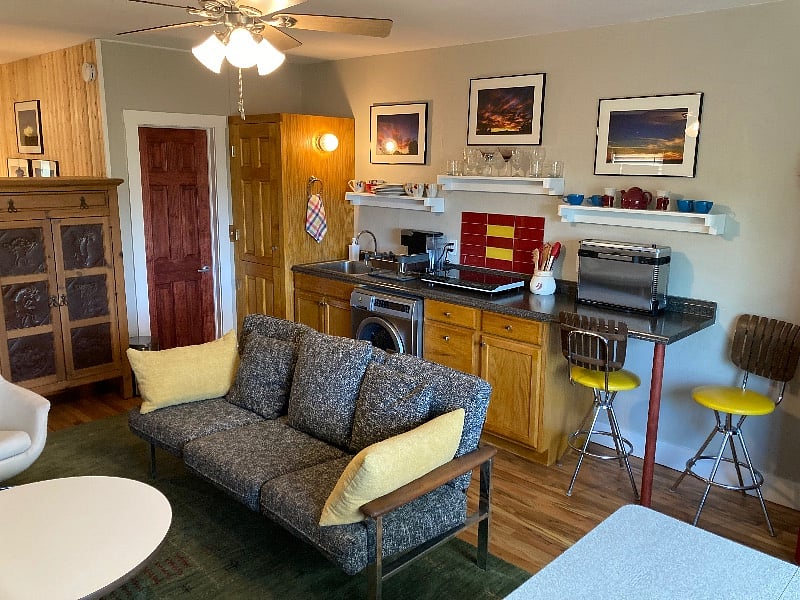 Bathroom is behind the red door. Front loading washing machine under the cabinet is convenient and quiet, two burner induction cooktop and Ninja Air fryer.