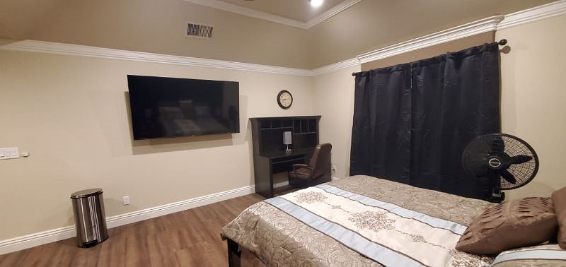Work desk with comfortable chair, and smart TV.