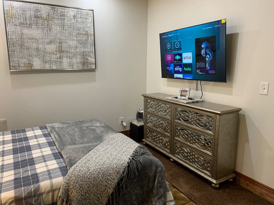 55 inch smart TV and dresser in bedroom