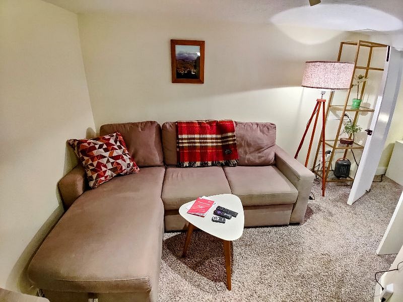 Cozy sectional couch pulls out into a full size trundle bed. Extra bedclothes located in the pop up storage lounger section