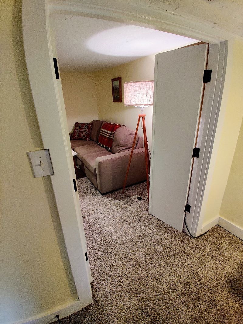 Bedroom is separate from living room with lockable doors