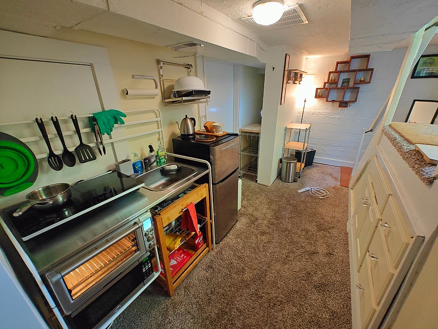 Fridge with seperate freezer, Breville convection oven, microwave, stainless steel countertop, pour over & automatic coffee machine, high powered cook top, pots, pans, utensils, cutting board etc... Coway air purifier & window in kitchen.