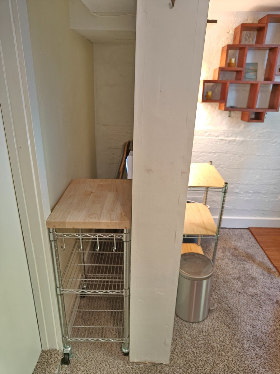 Pantry shelving, butcher block, additional storage space.