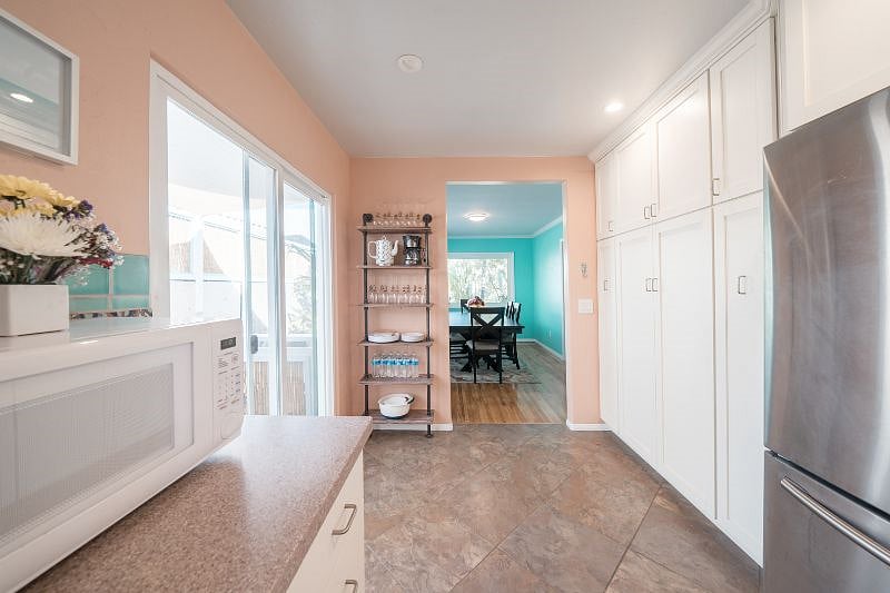 Chefs kitchen looking to formal dining room.