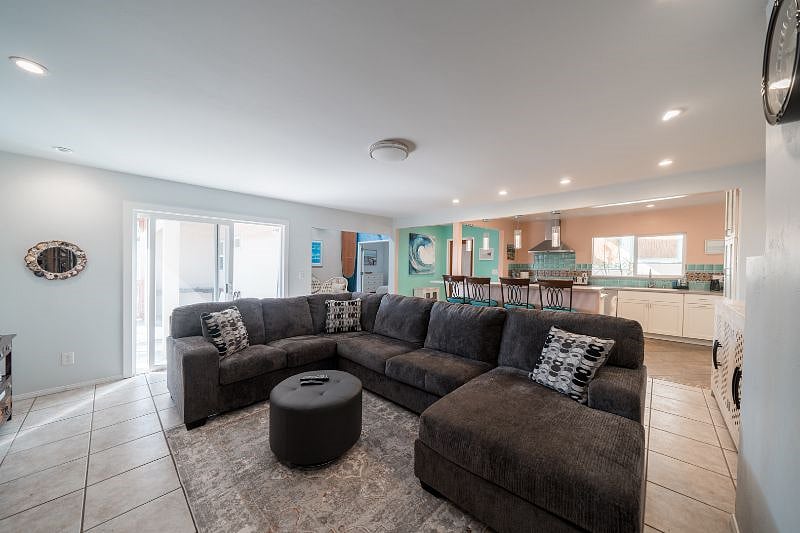 Large den with smart TV and slider to deck area.