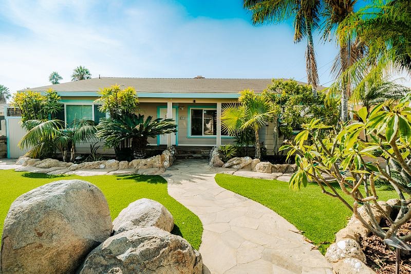 Front of house with beautiful landscape.