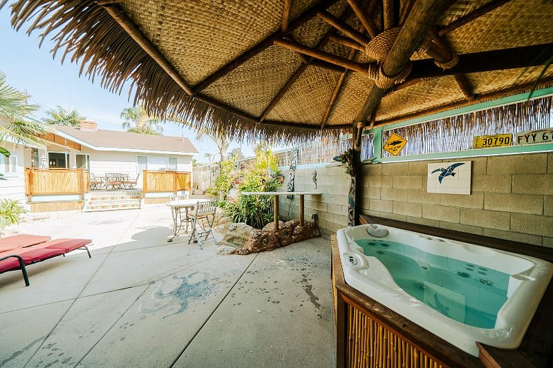 Jacuzzi under palapa with market lights.