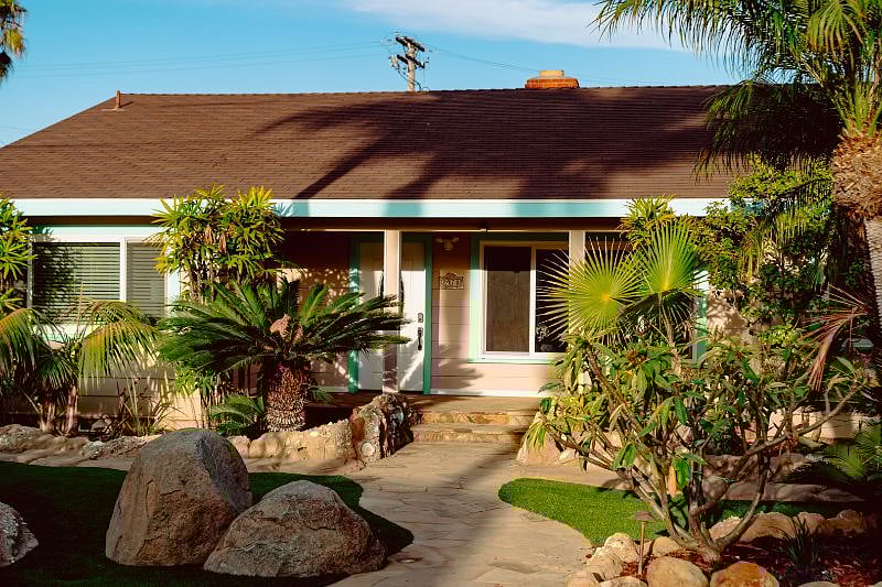 Front of house with beautiful landscape.