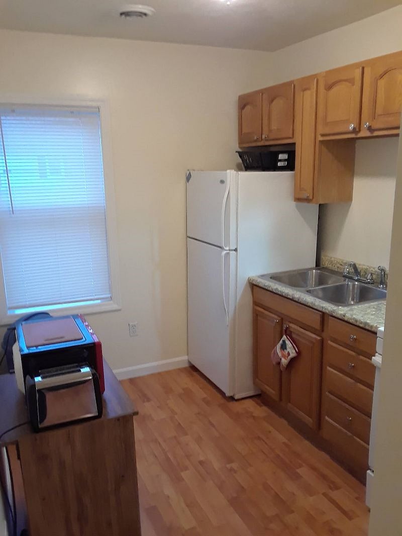 Fully stocked kitchen with full size refrigerator, cooking stove with oven, microwave, toaster and coffee pot.