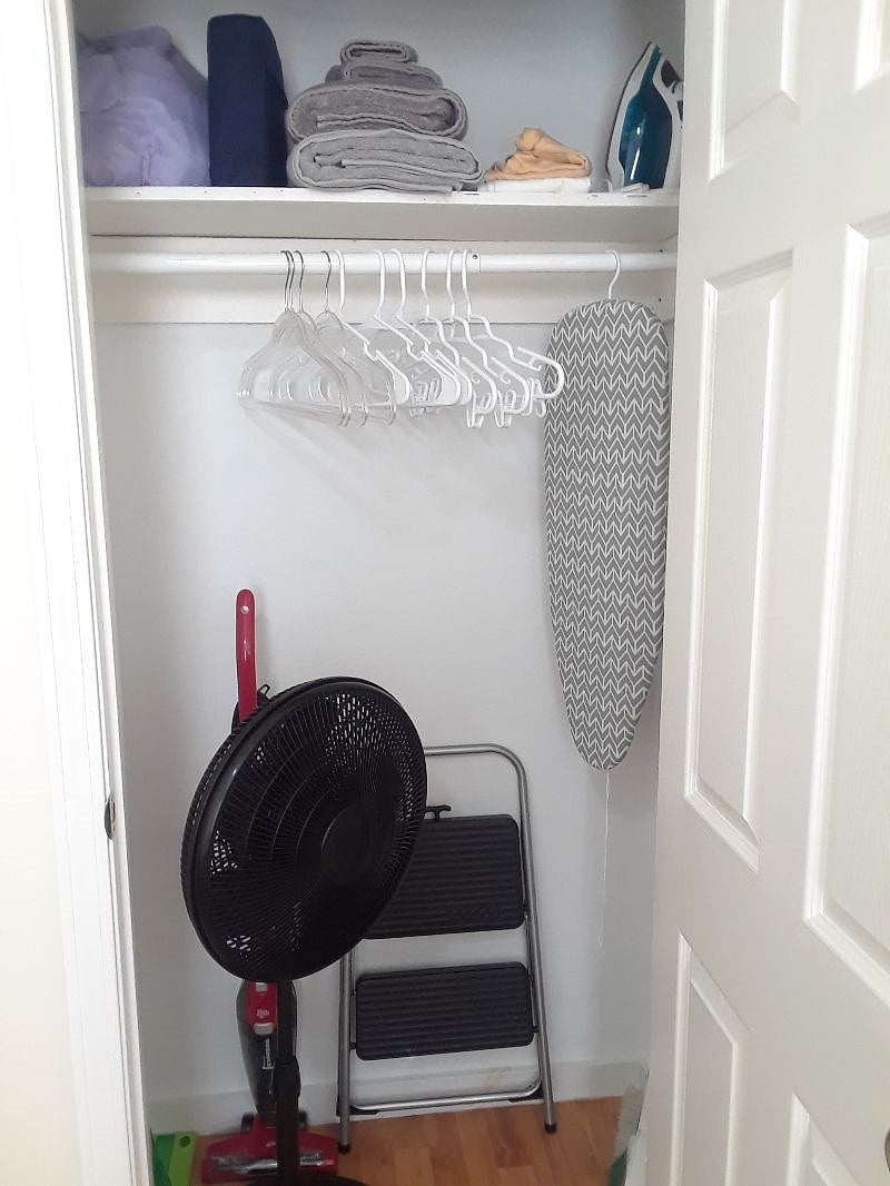 Linen closet with clean bed and bath linens, fan, ironing board, iron, hangers. Starter cleaning products. Everything you need to keep your apartment clean.