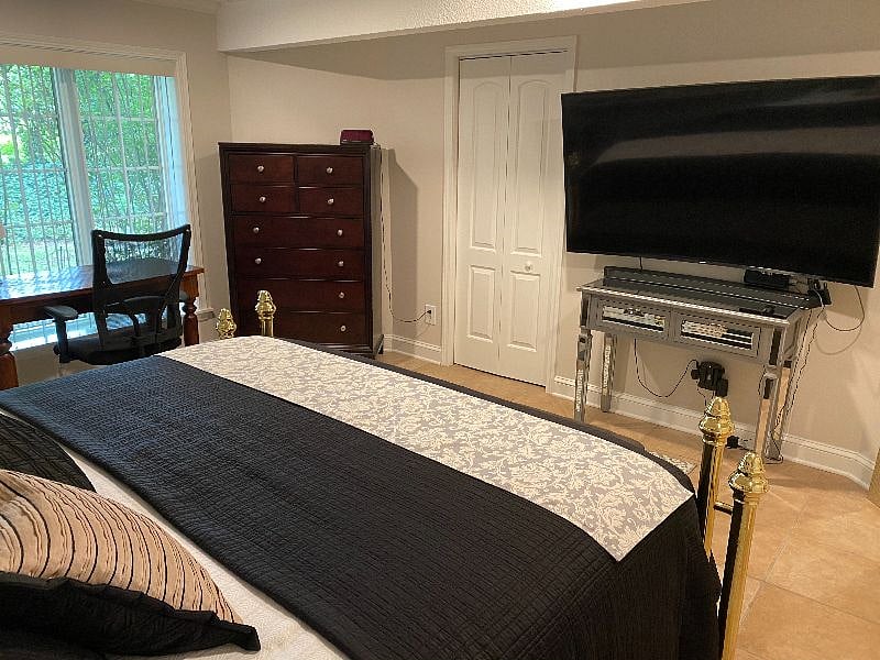 Bedroom TV (45") large dresser for clothing, big window with work at home desk.