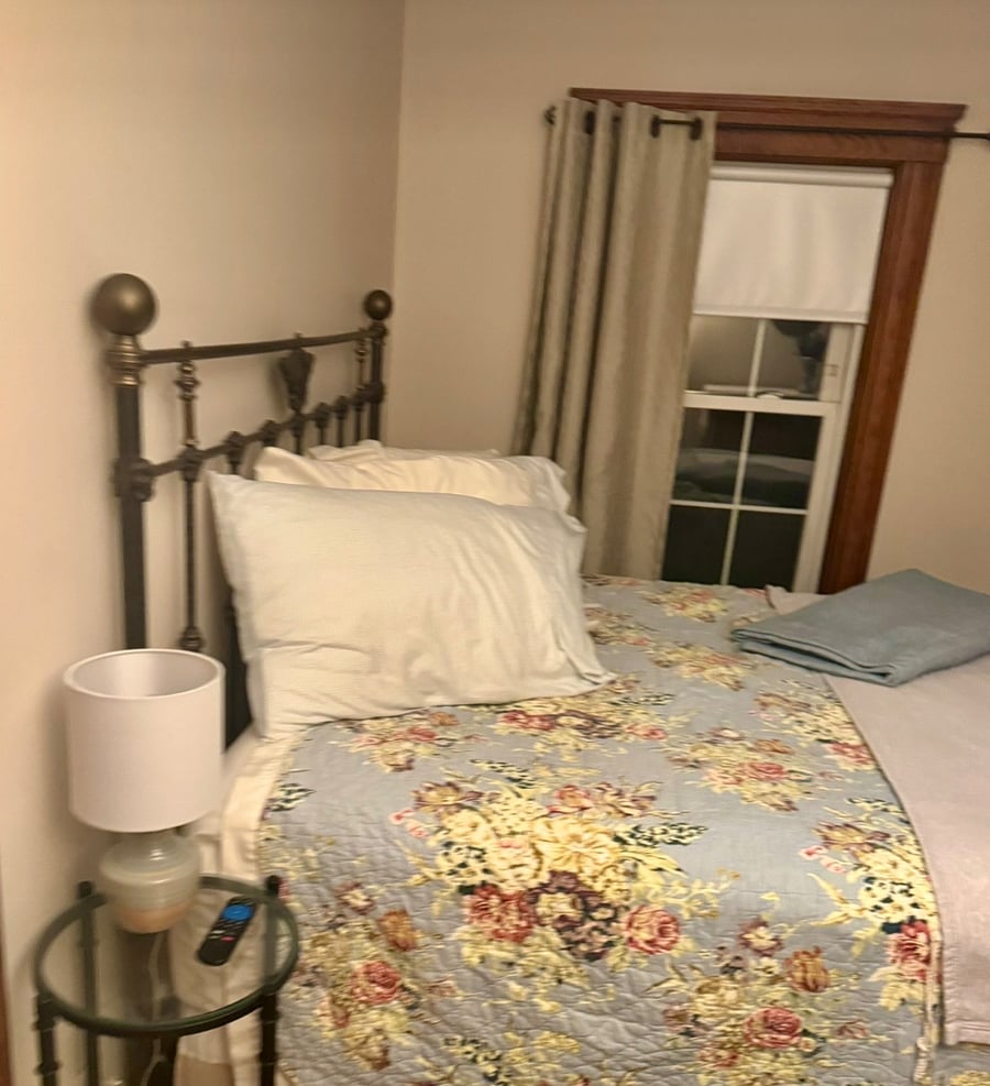 Night picture of you room, queen sized bed, black out drapes and room darkening shades