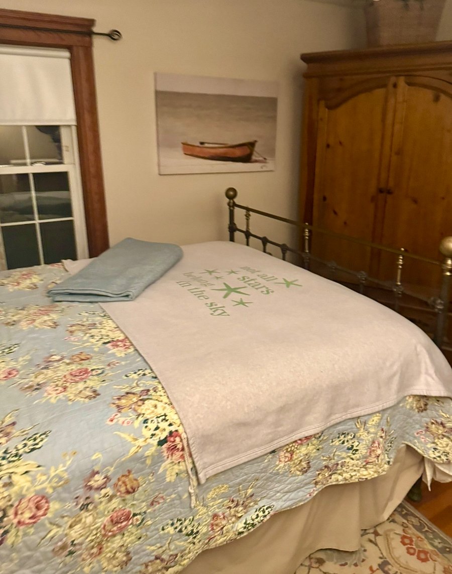 Your room (at night) with queen sized bed, Armoire with TV in it
