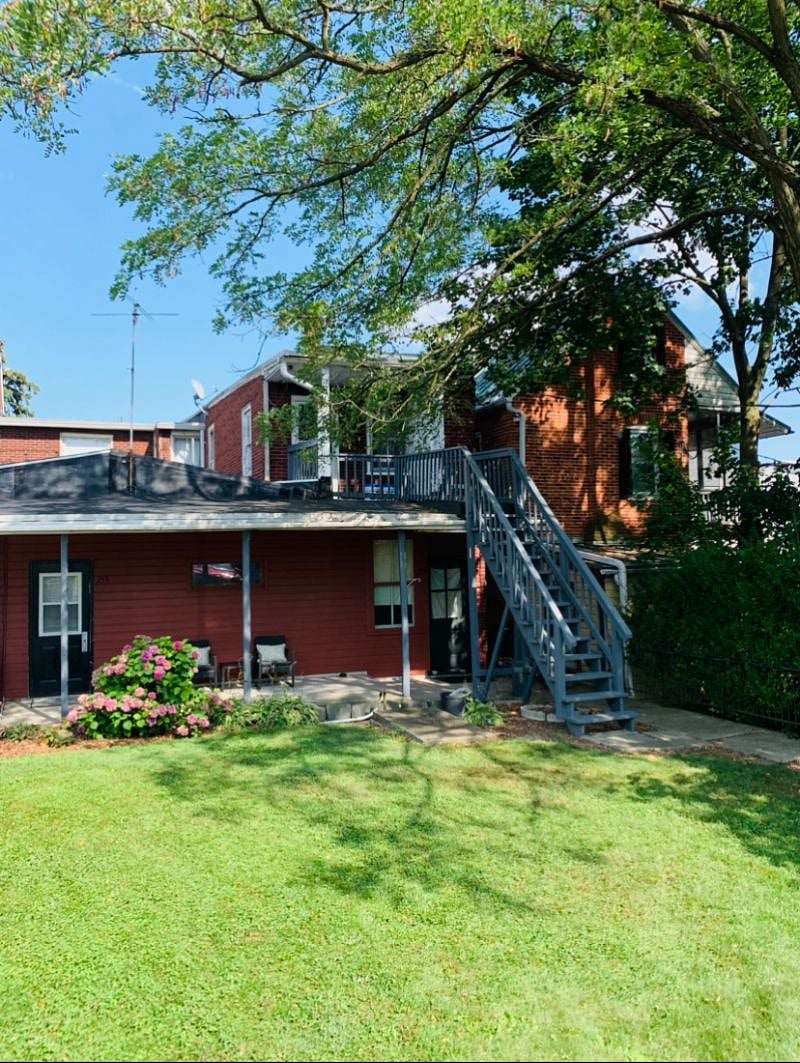 Back of house with yard. Parking area is located just behind yard.