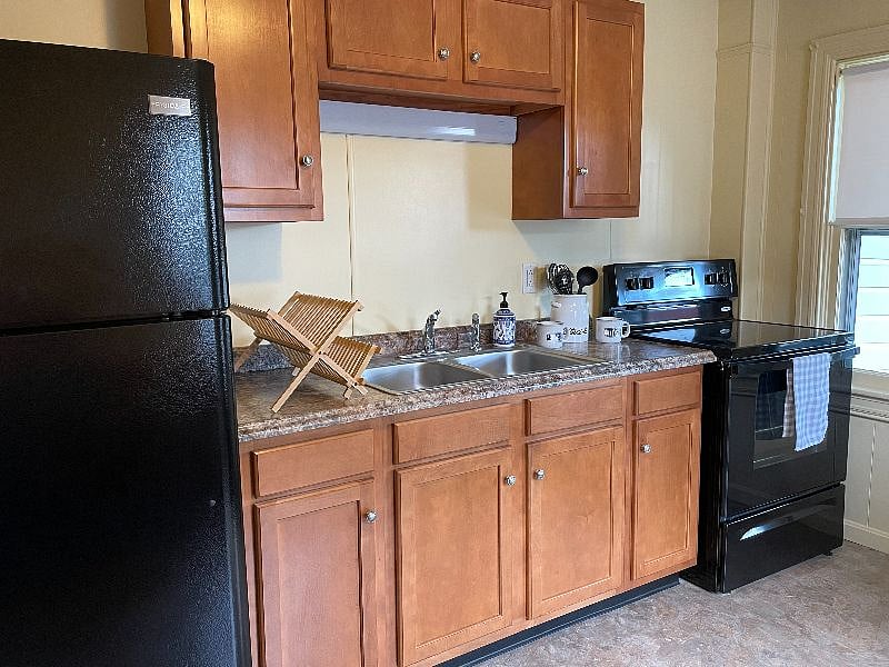 Fully equipped kitchen with all standard appliances (stove, refrigerator, coffee pot, toaster, microwave, etc.).