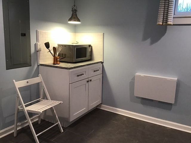 Kitchen features folding table and chair