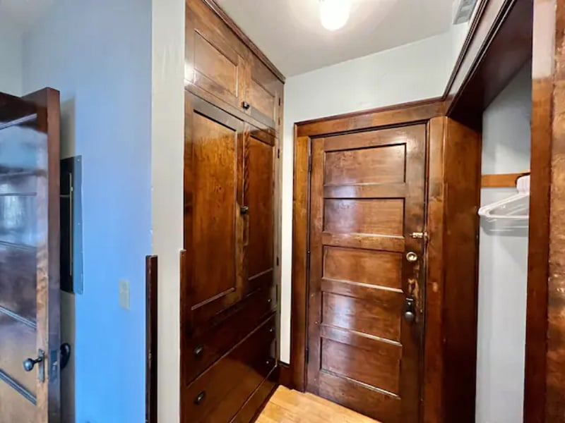 Entrance to apartment from the inside. Closet with drawers on left. Closet with hangers on the right.