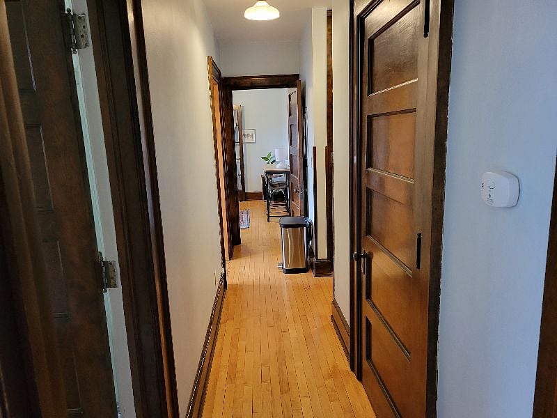 View from back bedroom, past the bathroom and kitchen and into the living room.