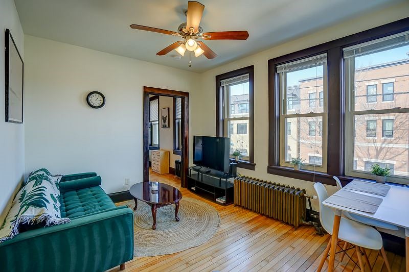 Living room. Large windows to let natural light in! View of Willy St below. 50" Roku Smart TV.
