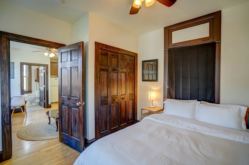 Bedroom with closet in background.
