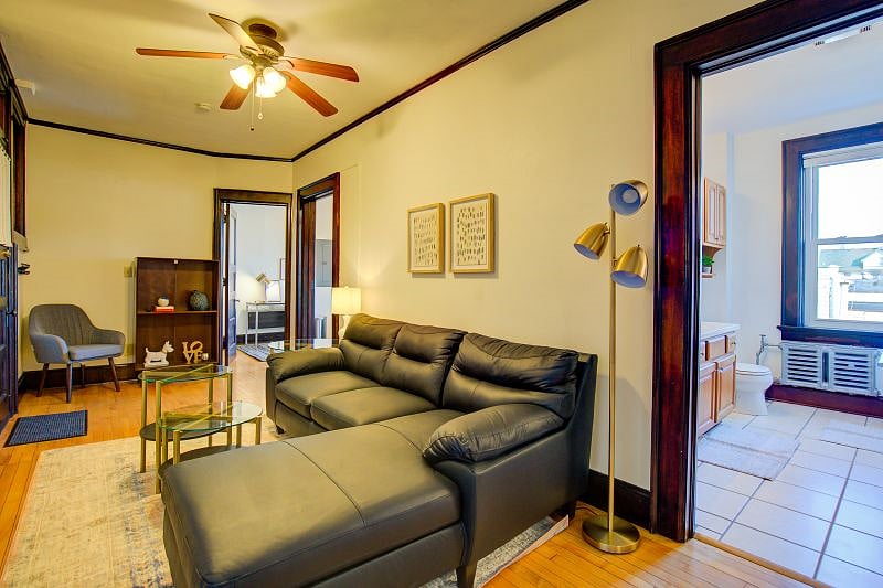 View of living room from bedroom entrance. Bathroom is to the right and office entrance is at the far end of the room! Kitchen entrance is the middle door.