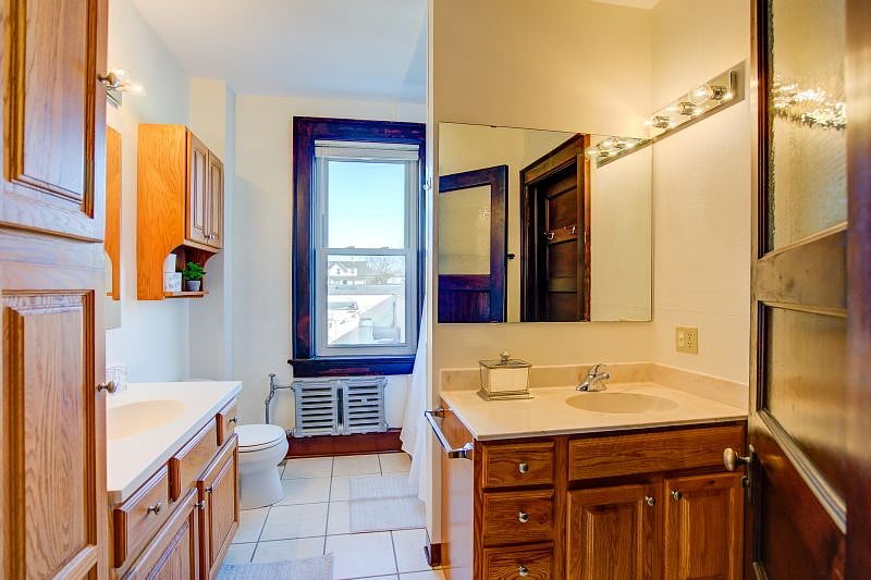 Bathroom with one shower/tub and two sinks. Extra cabinet space for any extra bathroom accessories you bring.