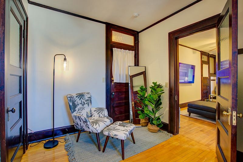 Bedroom with reading chair. Closet is to the left.
