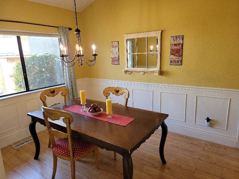Formal dining area with light coming in from side yard.