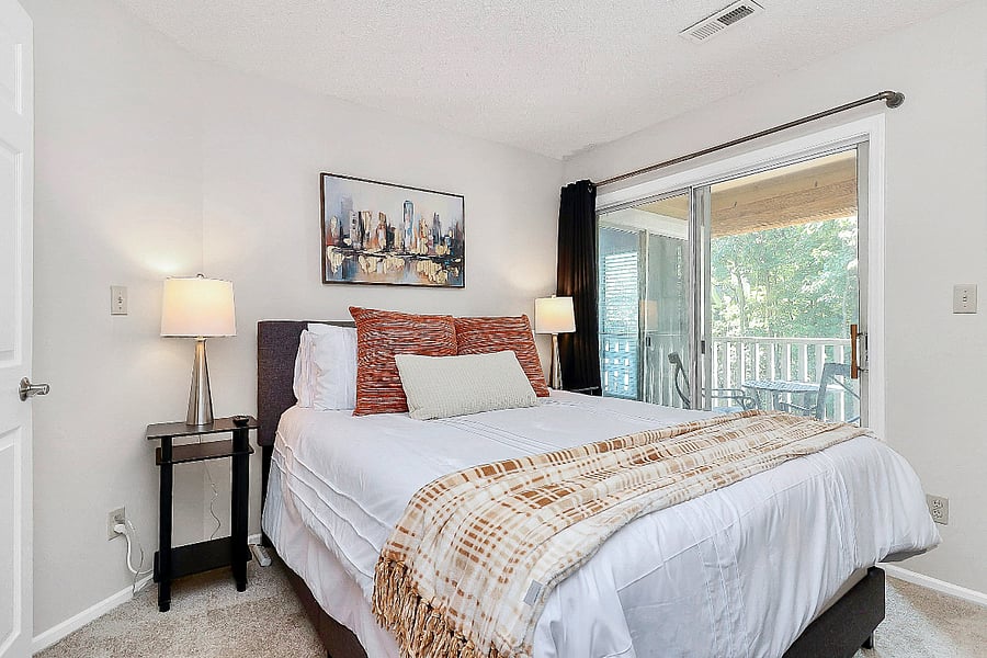 Unwind and relax in this quiet queen bedroom oasis with direct access to the private balcony.
