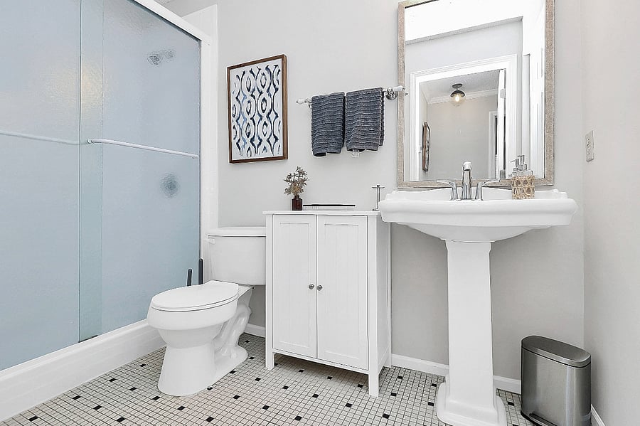 Bathe in this full bathroom with walk in shower and pedestal sink