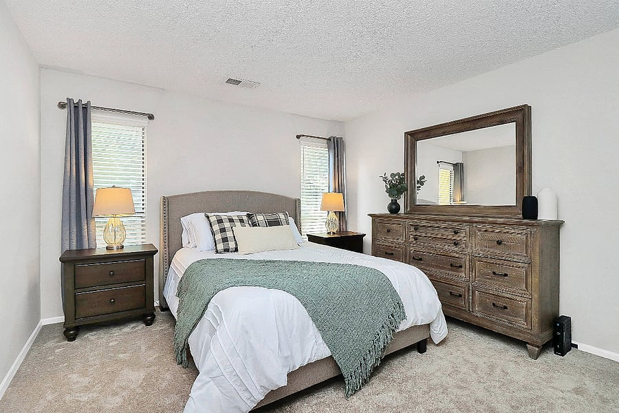 Lounge in this spacious master bedroom with walk in closet and blackout curtains