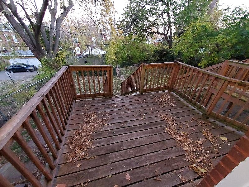 View out kitchen door to shared back deck and back yard