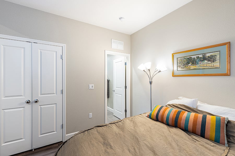 Bedroom with view of closet and bathroom doors. 