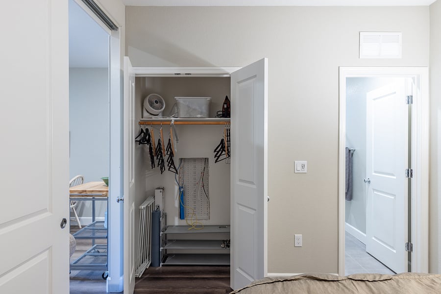 Closet open to show interior. Hangers, shoe rack, yoga mat, fan, extra towels iron and ironing board included. 