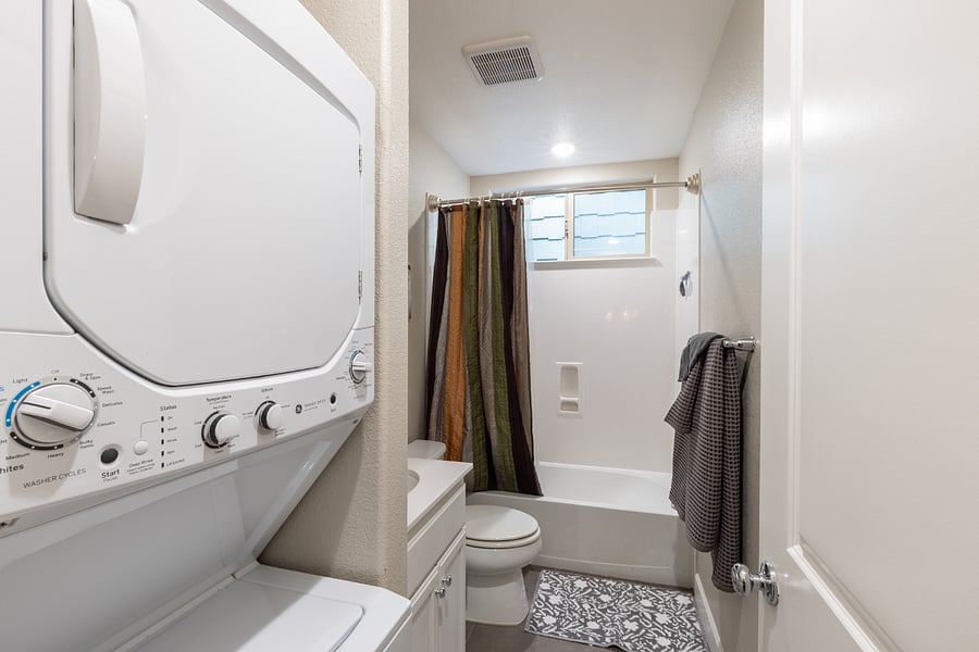 Laundry unit (washer and drier) are in the bathroom. 