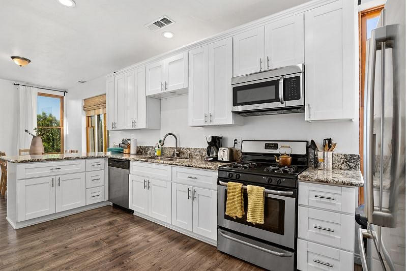 Full kitchen with utensils, pots and pans, and other essentials to cook.