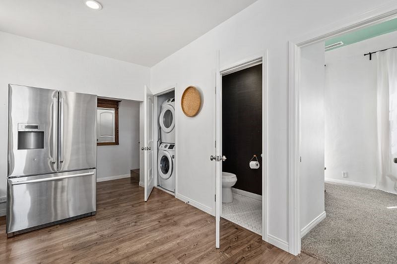 Stacked Samsung washer and dryer right off the kitchen area are free to use.