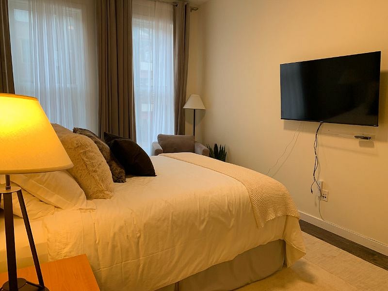 Watch 55-inch TV from comfort of your bed or sitting area.