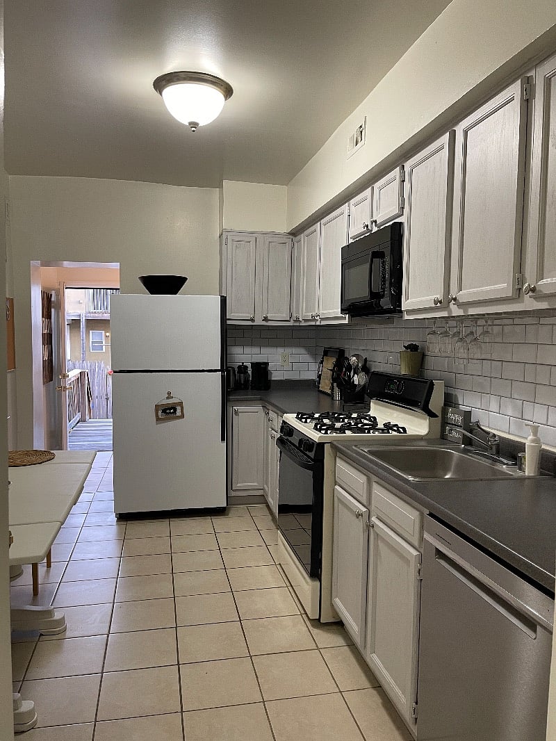 Kitchen with plenty of storage (2 windows to the left)