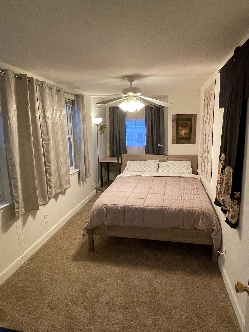 Queen room with black out shades all the way. It has 3 windows if you prefer light & bright! Also, a ceiling fan.