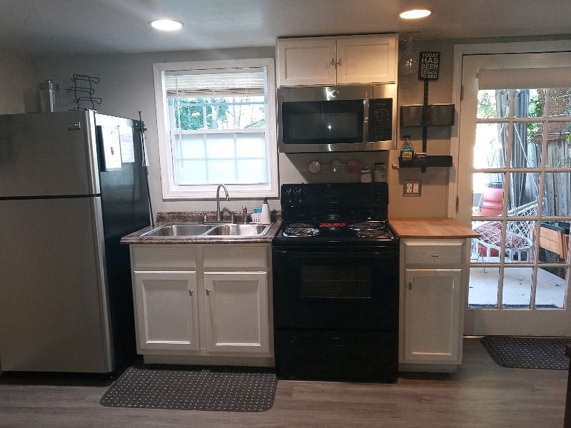 Full electric stove & a full fridge.