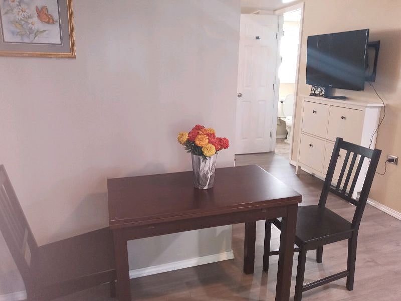 Table with two chairs for sitting to eat or drink your coffee.