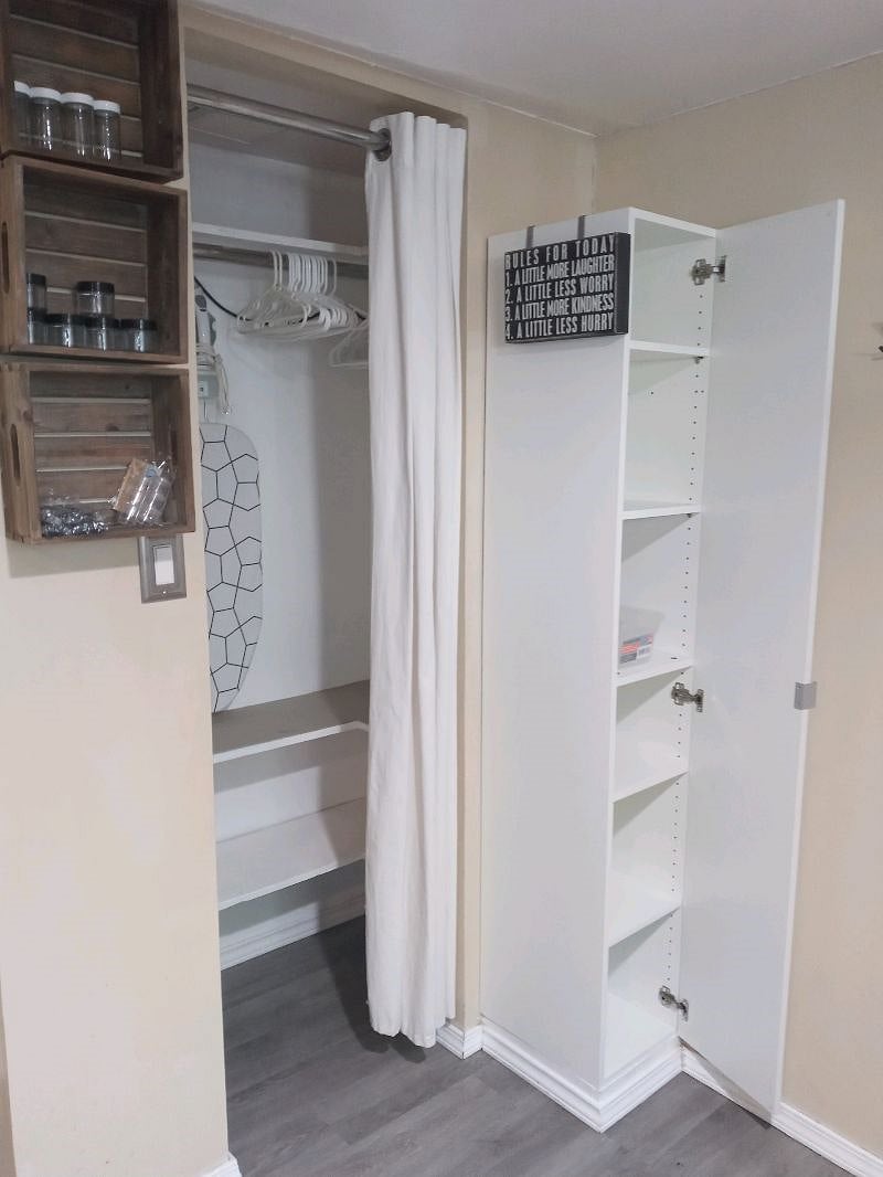 Small closet with hangers & shelves on the left and a small pantry for food.
