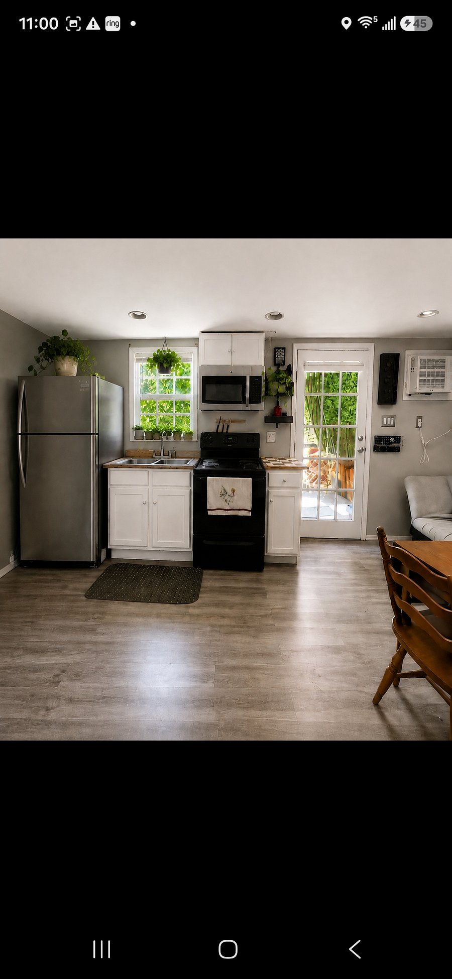 Full refrigerator, full gas stove. View to the sitting area and pomegranate and fig trees.