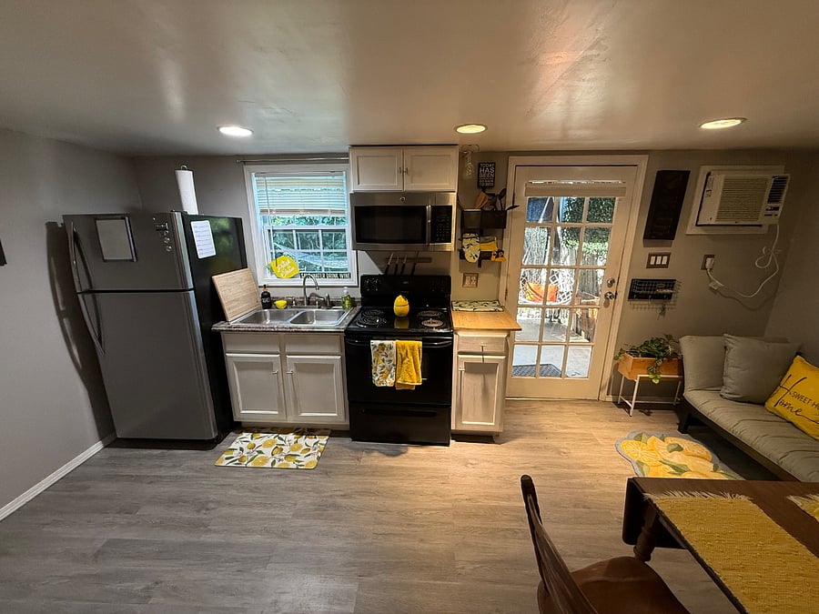 Full size stove and refrigerator. Door leads to your front porch where you can still and enjoy the outdoors.