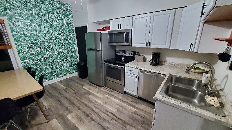 The red pots and pans, fun wallpaper, and other happy touches are meant to give you smiles even when work has been hard.