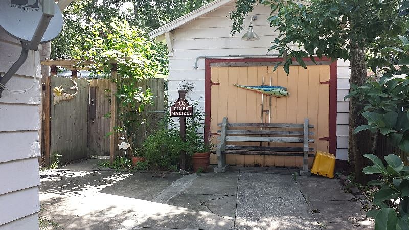 Original garage and toolshed are a second property on the lot.