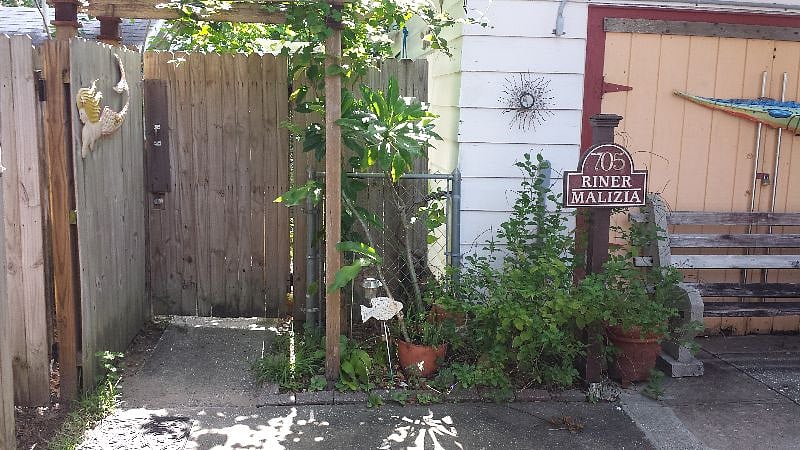Original garage and toolshed are a second property on the lot.