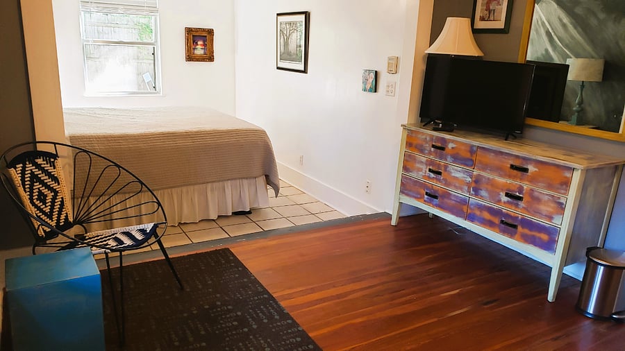 Sunken king-sized bedroom with streaming TV.
